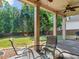 View of the back patio with a ceiling fan and outdoor seating, overlooking the well-maintained lawn at 570 Mcgarity Dr, Mcdonough, GA 30252