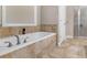 Oversized soaking tub with tile surround, adjacent to the walk-in shower at 570 Mcgarity Dr, Mcdonough, GA 30252