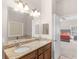 Granite dual sink vanity, walk in shower with glass door, and entrance to main bedroom at 570 Mcgarity Dr, Mcdonough, GA 30252