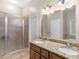 Granite dual sink vanity, walk in shower with glass door, and adjacent tub at 570 Mcgarity Dr, Mcdonough, GA 30252