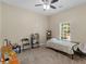 Bedroom features carpet, ceiling fan, a window, single bed, a folding chair, and a table with shelving at 570 Mcgarity Dr, Mcdonough, GA 30252