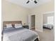 This bedroom features carpet, a ceiling fan, a bed with headboard, and closet with sliding mirror doors at 570 Mcgarity Dr, Mcdonough, GA 30252