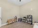 Bedroom with carpet and features a ceiling fan, a folding chair, shelving, and a small table at 570 Mcgarity Dr, Mcdonough, GA 30252