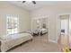 Bedroom featuring carpet, ceiling fan, closet with mirror sliding doors, and a view of the neighborhood at 570 Mcgarity Dr, Mcdonough, GA 30252