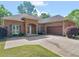 Charming brick home with a two-car garage, beautiful landscaping, and a well-maintained lawn at 570 Mcgarity Dr, Mcdonough, GA 30252