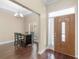 Inviting foyer featuring hardwood floors, elegant lighting, and a view into the dining area at 570 Mcgarity Dr, Mcdonough, GA 30252