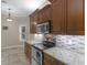 Updated kitchen features granite countertops, tile backsplash, and stainless steel appliances at 570 Mcgarity Dr, Mcdonough, GA 30252
