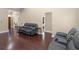 Open-concept living room featuring rich hardwood floors and comfortable leather seating at 570 Mcgarity Dr, Mcdonough, GA 30252