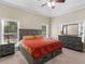 Bright main bedroom with tray ceilings, furniture set, and natural light from two windows at 570 Mcgarity Dr, Mcdonough, GA 30252