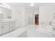 Sleek bathroom featuring dual sinks, a soaking tub, and a glass-enclosed shower at 214 Trecastle Sq, Canton, GA 30114