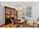 Cozy breakfast nook with round wood table and custom built-in shelving, perfect for casual dining at 214 Trecastle Sq, Canton, GA 30114