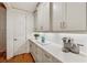 Butler's pantry features sleek white cabinets, quartz counters, subway tile backsplash, and modern fixtures at 214 Trecastle Sq, Canton, GA 30114
