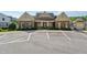 Community clubhouse exterior featuring manicured landscaping and ample parking at 214 Trecastle Sq, Canton, GA 30114