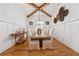 Formal dining room boasts wood beams, wainscoting, hardwood floors and stylish decor at 214 Trecastle Sq, Canton, GA 30114
