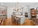 Open-concept kitchen features an island with bar seating, and stainless appliances at 214 Trecastle Sq, Canton, GA 30114