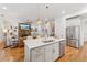 Spacious open kitchen with island seating and stainless appliances, flows into the living area at 214 Trecastle Sq, Canton, GA 30114