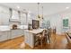 Bright kitchen with island, stainless appliances, and stylish pendant lighting, seamlessly blends style and function at 214 Trecastle Sq, Canton, GA 30114