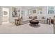 Inviting living room with neutral tones, plush sofa, ottoman, and art at 214 Trecastle Sq, Canton, GA 30114