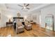 Spacious main bedroom with tray ceiling, two seating chairs, and hardwood flooring at 214 Trecastle Sq, Canton, GA 30114
