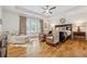 A relaxing main bedroom showcasing hardwood floors, seating area, and a large window at 214 Trecastle Sq, Canton, GA 30114