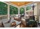 Relaxing outdoor patio with comfortable seating and wooded views at 214 Trecastle Sq, Canton, GA 30114