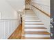 Elegant entry hallway with hardwood floors and an open staircase with wood railing at 214 Trecastle Sq, Canton, GA 30114