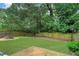 Large, grassy backyard with wood privacy fence and a fire pit area, perfect for outdoor enjoyment at 381 New Jersey Ave Nw, Atlanta, GA 30314