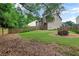 Spacious backyard featuring a lush lawn, wooden fence, and a charming fire pit area perfect for outdoor entertaining at 381 New Jersey Ave Nw, Atlanta, GA 30314