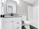 Modern bathroom with granite countertop, black fixtures, white cabinets, and a shower-tub combo at 381 New Jersey Ave Nw, Atlanta, GA 30314