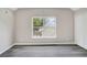 Bright bedroom featuring a large window, modern gray floors, and a spacious closet at 381 New Jersey Ave Nw, Atlanta, GA 30314