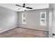 Neutral bedroom with carpet, ceiling fan, and natural light from two windows at 381 New Jersey Ave Nw, Atlanta, GA 30314