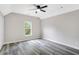 Bright room with a ceiling fan, modern gray floors, and a large window at 381 New Jersey Ave Nw, Atlanta, GA 30314