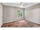 Bright bedroom featuring neutral walls, trim, carpet, ceiling fan and a large window at 381 New Jersey Ave Nw, Atlanta, GA 30314