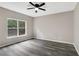 Neutral bedroom featuring modern ceiling fan, gray walls, and luxury vinyl plank flooring at 381 New Jersey Ave Nw, Atlanta, GA 30314