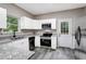 Modern kitchen with white cabinets, granite countertops, and stainless steel appliances at 381 New Jersey Ave Nw, Atlanta, GA 30314