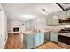 Open kitchen with granite countertops, stainless steel appliances, and a view of the living room at 381 New Jersey Ave Nw, Atlanta, GA 30314