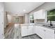 Bright kitchen with white cabinets, granite countertops, and open view to living room at 381 New Jersey Ave Nw, Atlanta, GA 30314