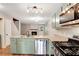 Open kitchen with granite countertops, stainless steel appliances, and a view of the fireplace at 381 New Jersey Ave Nw, Atlanta, GA 30314
