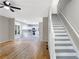 Open-concept living space with hardwood floors, stairs, and seamless flow into the kitchen at 381 New Jersey Ave Nw, Atlanta, GA 30314