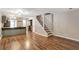 Open-concept living space with hardwood floors, staircase, and breakfast bar at 381 New Jersey Ave Nw, Atlanta, GA 30314