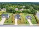 Aerial view of three similar single-Gathering homes surrounded by lush, mature trees at 4323 Cannon Walk, Ellenwood, GA 30294