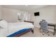 Bedroom with an office space, a mounted TV, and a dark wood bedframe at 4323 Cannon Walk, Ellenwood, GA 30294