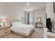 Bright bedroom features a comfortable bed, dresser, and a window with blue curtains at 4323 Cannon Walk, Ellenwood, GA 30294