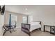 Bedroom with a dark wood bedframe, an office desk, and blue curtains at 4323 Cannon Walk, Ellenwood, GA 30294