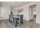 Bright dining room featuring a wooden dining table and six gray chairs with a striped rug at 4323 Cannon Walk, Ellenwood, GA 30294