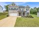 Charming two-story brick home featuring a well-manicured lawn and inviting front porch at 4323 Cannon Walk, Ellenwood, GA 30294