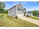 Angle view of a two-story home with brick and siding, a spacious lawn, and driveway at 4323 Cannon Walk, Ellenwood, GA 30294