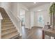 Welcoming foyer featuring hardwood floors, a staircase, and an elegant entry table with decor at 4323 Cannon Walk, Ellenwood, GA 30294