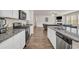 Kitchen features white cabinetry, granite countertops, stainless steel appliances, and a gas range at 4323 Cannon Walk, Ellenwood, GA 30294