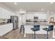 Bright kitchen with white cabinetry, granite countertops, stainless steel appliances, and island seating at 4323 Cannon Walk, Ellenwood, GA 30294